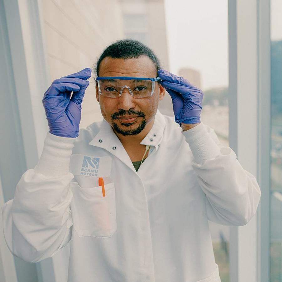 Grad student with goggles and labcoat poses in  ISC